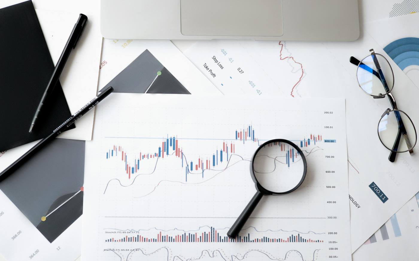 magnifying glass on top of a financial chart